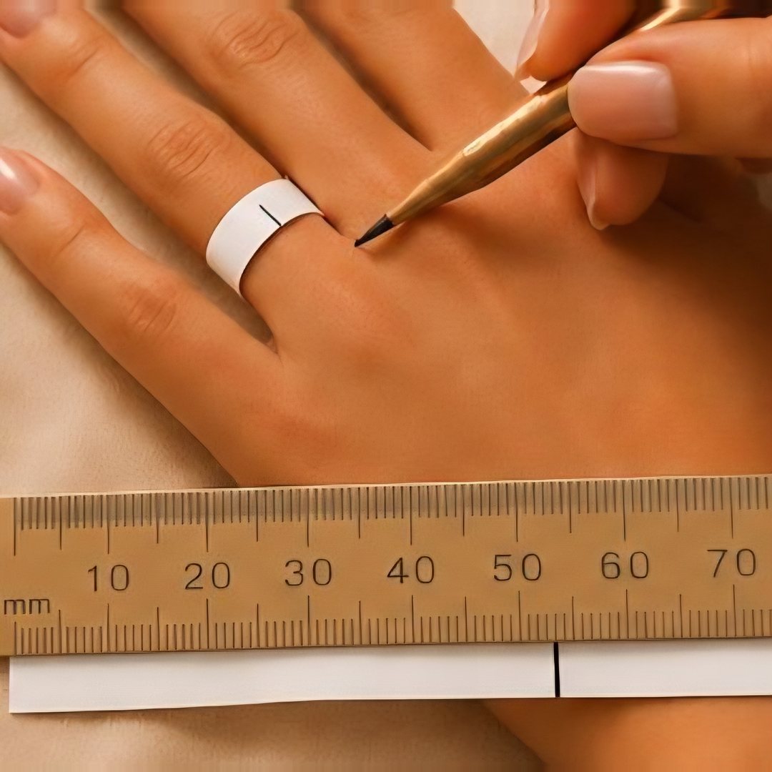 Marking a paper strip on the finger and measuring its length against a ruler